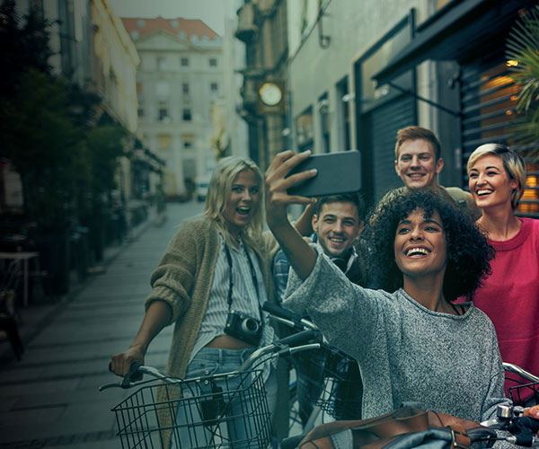 Group of friends on bikes using their phone